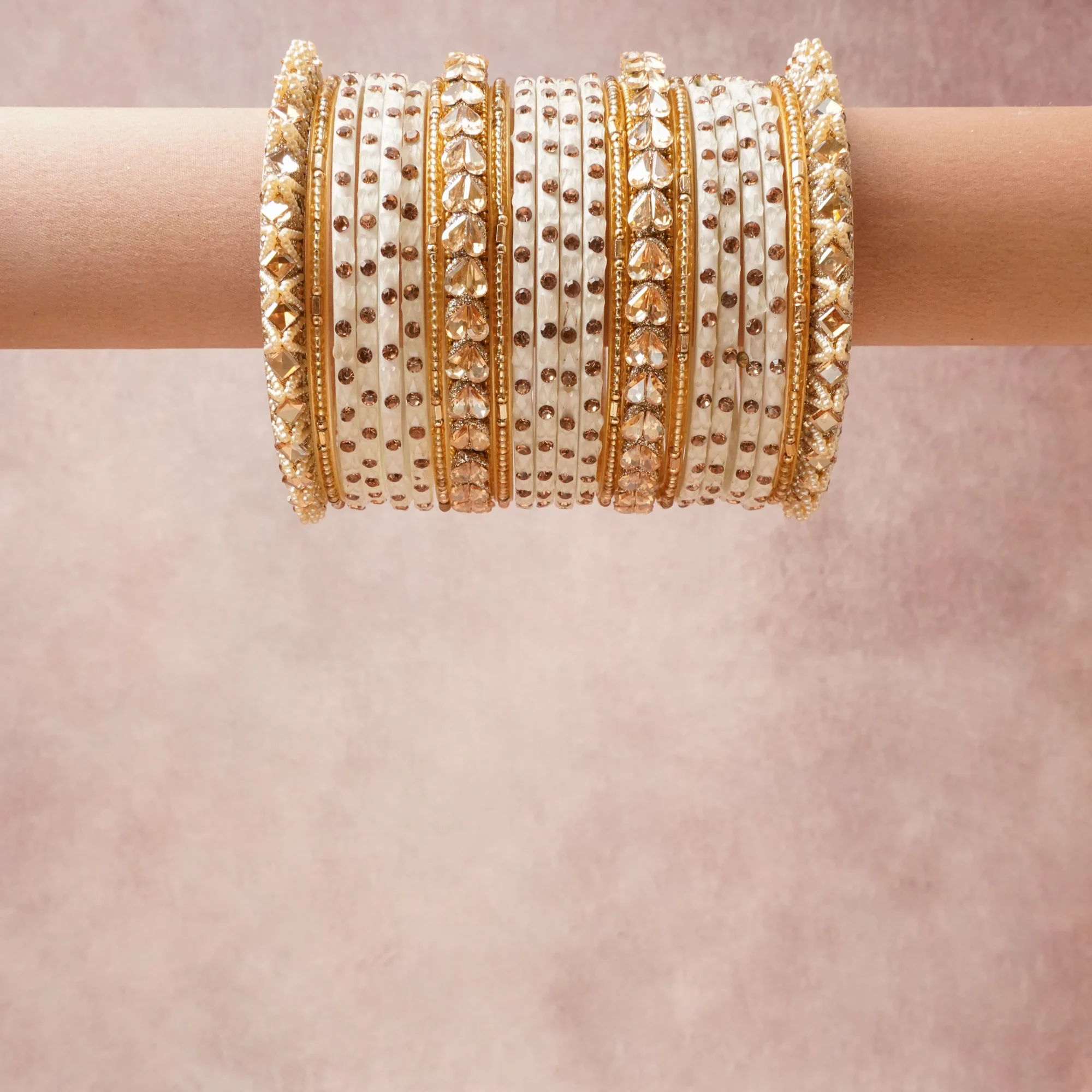 A grounding Ivory forms the heart of the set, while touches of Gold, Peach Crystal, Seed Pearl add charm.

A thoughtful composition of Gold-toned Metal, Enamel, Glass Crystals, Faux Pearls, designed to feel complete without being heavy.
Each element layers seamlessly, creating a look that is refined, wearable and quietly striking.